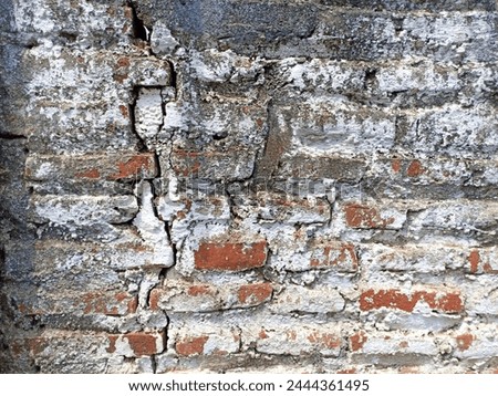 Old walls from red bricks that are starting to crack