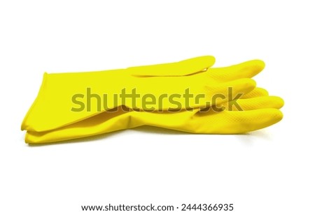 Two yellow gloves isolated on a white background Royalty-Free Stock Photo #2444366935