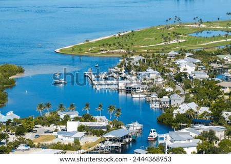 Rich neighborhood with expensive vacation homes in Boca Grande, small town on Gasparilla Island in southwest Florida. Wealthy waterfront residential area Royalty-Free Stock Photo #2444368953