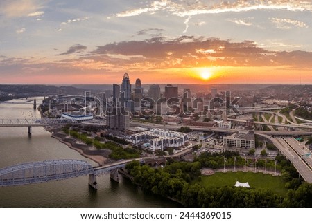 Cincinnati city, Ohio USA. View from above of brightly illuminated high skyscraper buildings in downtown district of American megapolis with business financial district at sunset