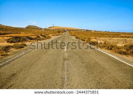 Photo Picture of a Beautiful Asphalt Lonely Road Royalty-Free Stock Photo #2444371851