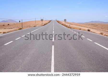 Photo Picture of a Beautiful Asphalt Lonely Road Royalty-Free Stock Photo #2444372959