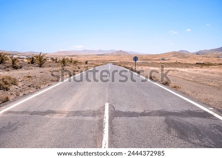 Photo Picture of a Beautiful Asphalt Lonely Road Royalty-Free Stock Photo #2444372985