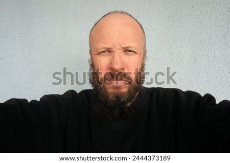 Men's beard. The guy's face is large. Brutal macho. Mustache and beard. Barber. Lumberjack. Portrait of a handsome man with a beard                                Royalty-Free Stock Photo #2444373189