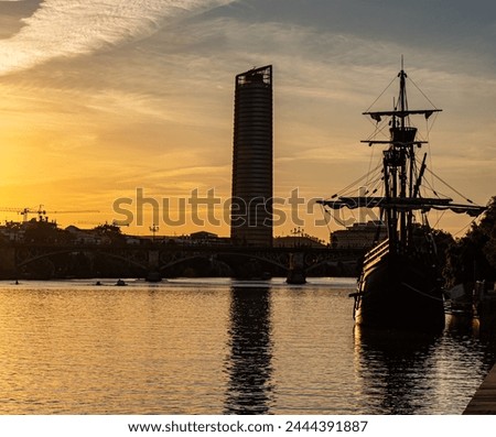 Nao Victoria and Torre Sevilla, beautiful sunset over the Guadalquivir river.