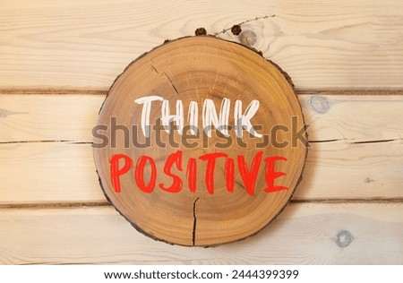 Think positive symbol. Concept words Think positive on beautiful wooden circle. Beautiful wooden wall background. Business, motivational think positive thinking concept. Copy space. Royalty-Free Stock Photo #2444399399