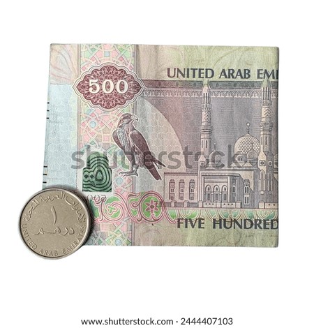 One dirham coin and 500 AED five hundred Dirhams banknote of United Arab Emirates, currency of the UAE with a picture of Sparrow hawk, selective focus of Emirates money banknote