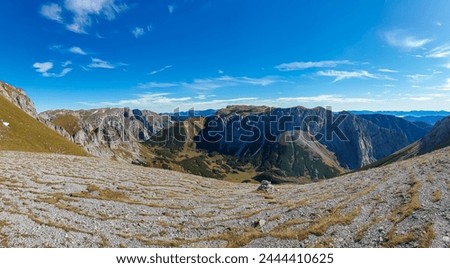 Panoramic view of majestic mountain peak Ringkamp in untamed Hochschwab mountain region, Styria, Austria. Scenic hiking trail on blue sky sunny day in remote Austrian Alps. Wanderlust in alpine spring Royalty-Free Stock Photo #2444410625