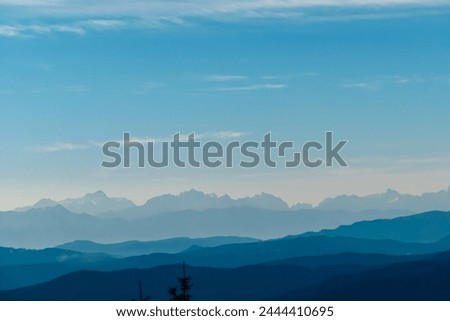 Panoramic view of magical mountain peaks of Karawanks and Julian Alps seen from Goldeck, Latschur group, Gailtal Alps, Carinthia, Austria, EU. Mystical atmosphere in Austrian Alps on sunny summer day. Royalty-Free Stock Photo #2444410695