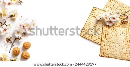 Matzo, decorated with almond flowers. On a white background. Pesach celebration concept (jewish Passover holiday)