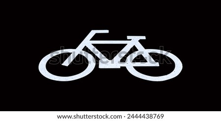 Bicycle symbol or sign on bicycle parking lot at roadside in town isolated on black background. Attention and alert sign or symbol.