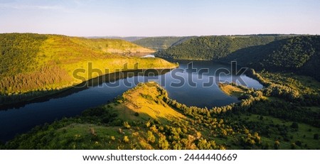 A peaceful view from above of the winding Dniester river. Location place Dnister canyon, Ukraine, Europe. Scenic image calm river. Drone photography. Photo wallpaper. Discover the beauty of earth.
