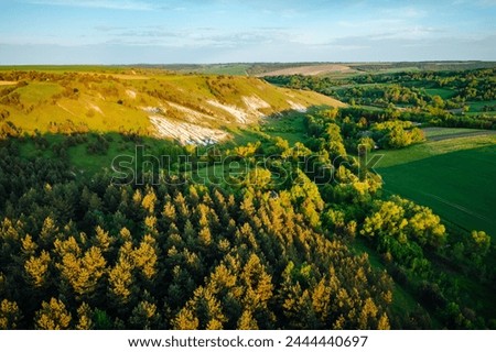 Picturesque summer scene of a rolling hills of rustic area from a bird's eye view. Top view, aerial photography. Vibrant photo wallpaper. Location place Ukraine, Europe. Beauty of earth.