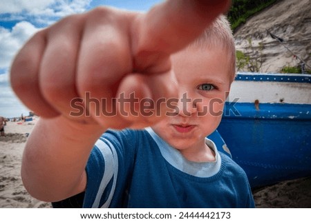 BOY POINTING FINGER AGAINST THE SKY