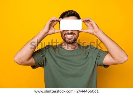Photo portrait of handsome young guy cover eyes white screen vr wear trendy khaki outfit isolated on yellow color background
