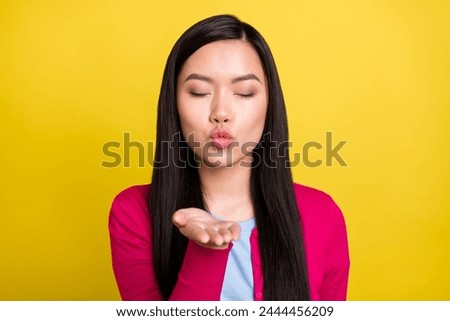 Photo of happy nice cheerful young woman send air kiss young closed eyes enjoy isolated on yellow color background