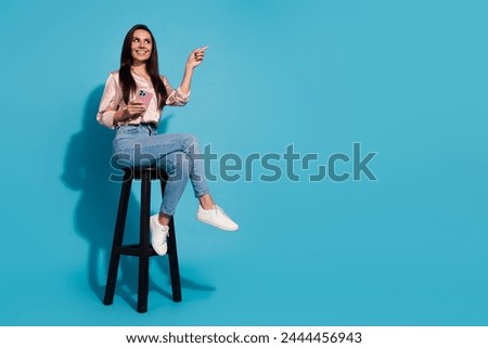 Full length photo of excited dreamy lady dressed shirt communicating modern gadget empty space isolated blue color background