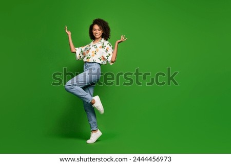 Full length photo of good mood excited woman dressed print shirt dancing empty space isolated green color background