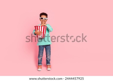 Full length photo of adorable little boy eat popcorn bucket watch film wear trendy aquamarine garment isolated on pink color background