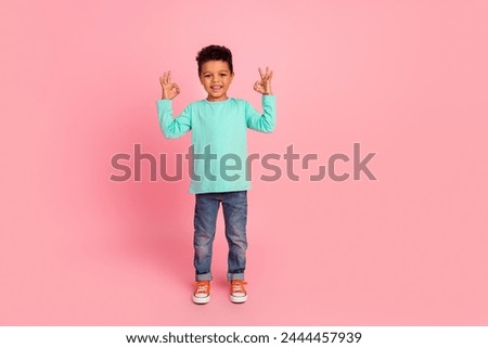 Full size photo of charming small boy show okey symbol good quality dressed stylish cyan clothes isolated on pink color background