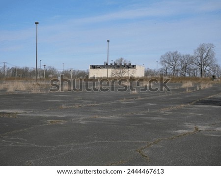 Old Run Down Overgrown Parking Lot Fort Monmouth NJ Royalty-Free Stock Photo #2444467613
