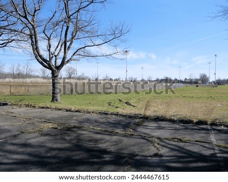 Old Run Down Overgrown Parking Lot Fort Monmouth NJ Royalty-Free Stock Photo #2444467615