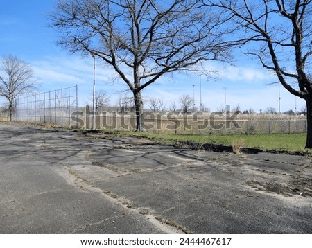 Old Run Down Overgrown Parking Lot Fort Monmouth NJ Royalty-Free Stock Photo #2444467617