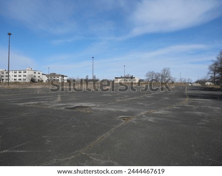 Old Run Down Overgrown Parking Lot Fort Monmouth NJ Royalty-Free Stock Photo #2444467619
