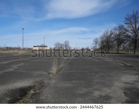 Old Run Down Overgrown Parking Lot Fort Monmouth NJ Royalty-Free Stock Photo #2444467625