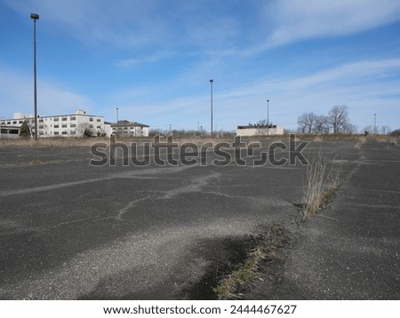Old Run Down Overgrown Parking Lot Fort Monmouth NJ Royalty-Free Stock Photo #2444467627