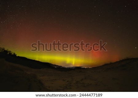 Aurora borealis in the night sky over the dunes