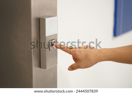 Cropped image, Selective focus on woman finger pressing on elevator button on the wall