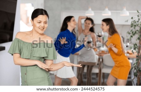 Woman dance during party with friends. Participant of gathering have fun and dance, spend time in pleasant company of fellows Royalty-Free Stock Photo #2444524575