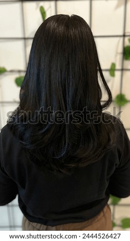 Girl’s beautiful waved black hair Royalty-Free Stock Photo #2444526427