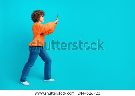 Full length profile side photo of persistent hardworking woman hands push billboard empty space isolated on blue color background