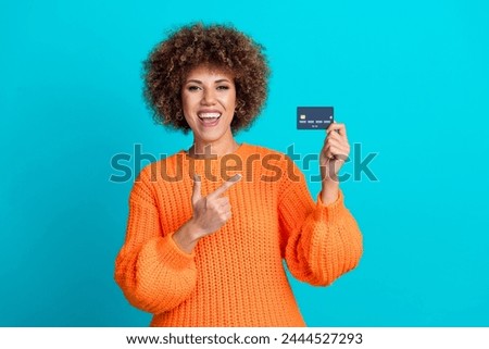 Photo of pretty excited girl indicate finger hand hold debit card empty space isolated on teal color background