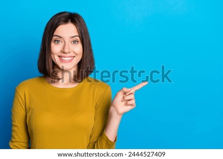 Photo of pretty adorable lady dressed shirt pointing finger empty space isolated blue color background