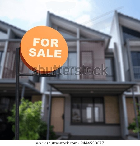 Pole sign with a for sale text with a real estate background. Real estate sales concept