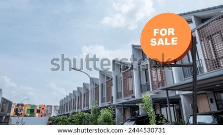 Pole sign with a for sale text with a real estate background. Real estate sales concept