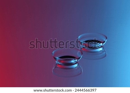 Pair of contact lenses on mirror surface. Space for text