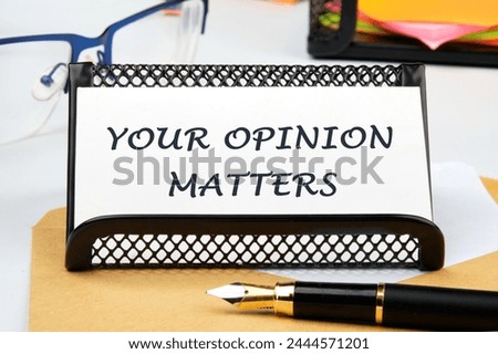 YOUR OPINION MATTERS phrase written on a business card on the table