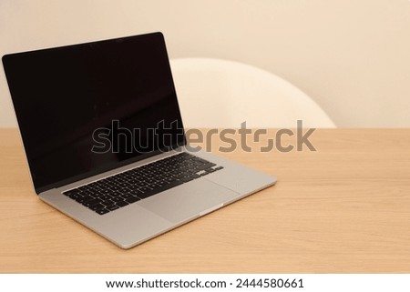 Modern laptop on wooden table. Space for text