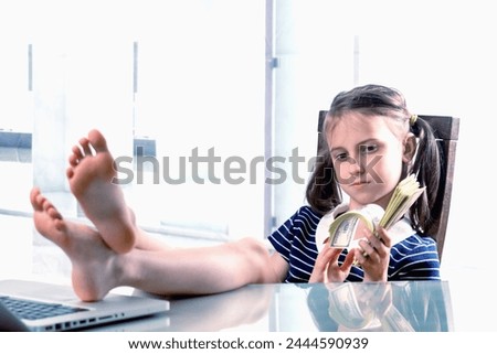 Humorous image of cheerful caucasian young girl counts profits