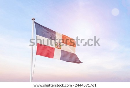 Dominican Republic flag with mast at amazing sunlight.