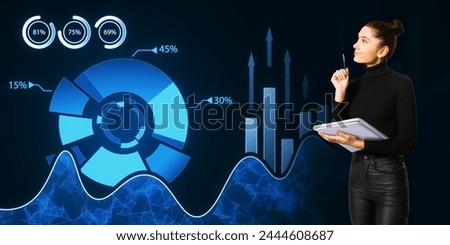 Thoughtful young woman with notepad and creative digital business pie chart on dark background. Glowing stock market analysis and big business data analysis
