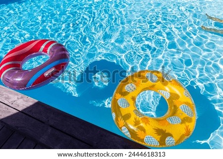 colorful buoy in a swimming pool in summer with blue waves and sunshine