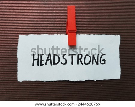 Headstrong writting on brown background.