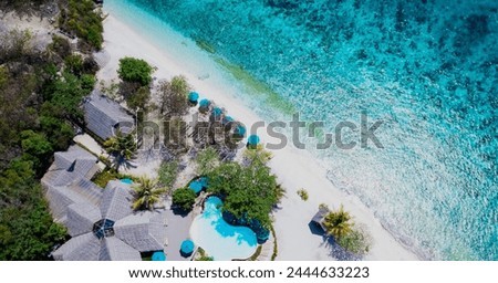Aerial view of the tropical with seashore as the island in a coral reef ,blue and turquoise sea Amazing nature landscape with blue lagoon