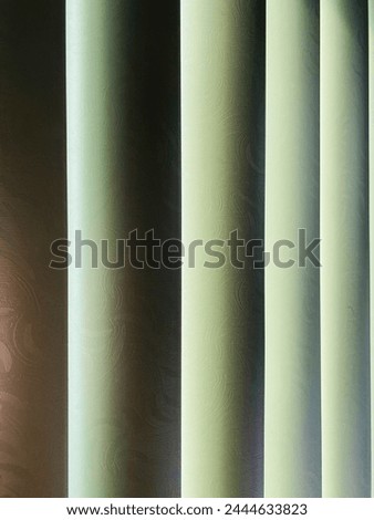 Dark background, streaks of light and darkness, closed blinds, design