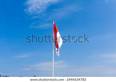 Indonesian flag under the concept of blue sky independence day, a combination of red and white as a symbol of Indonesia